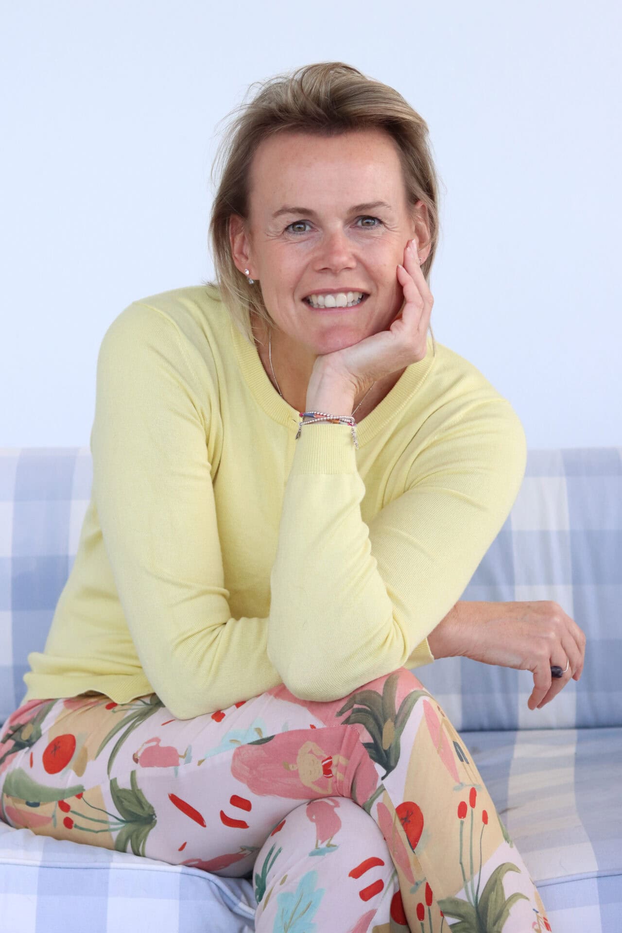 Kerrin bain seated on a couch smiling into the camera